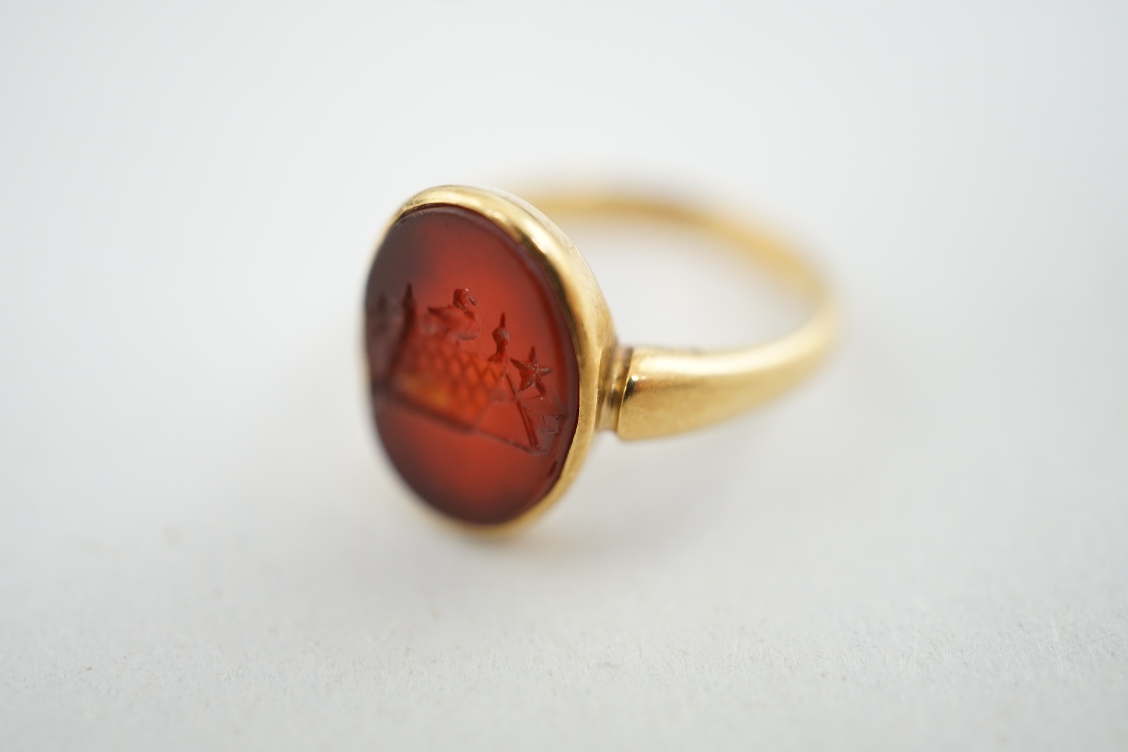 A Victorian 18ct gold and intaglio carnelian set child's signet ring